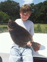 Boy holding flounder